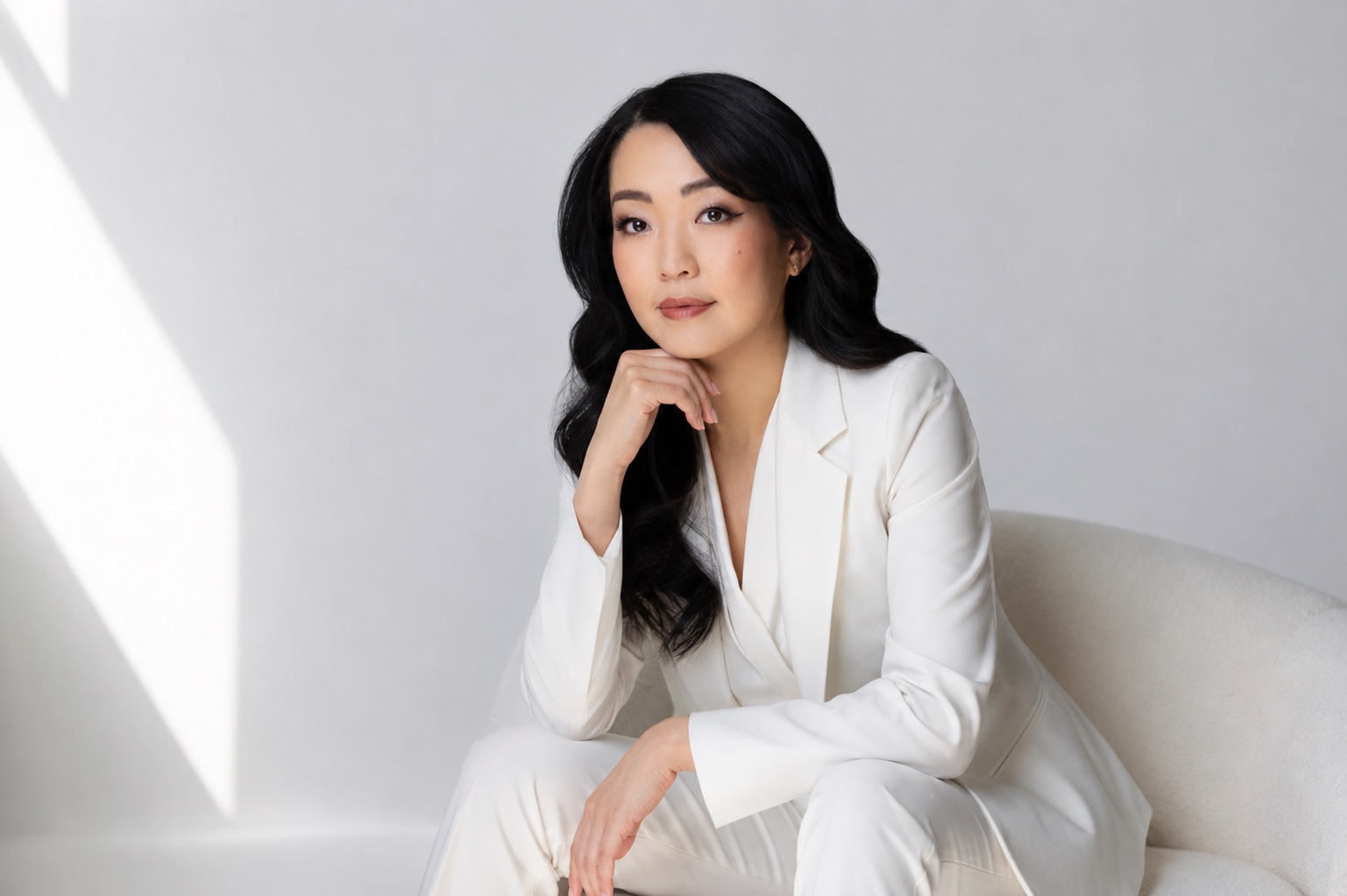 Midya U, standing portrait in a white suit